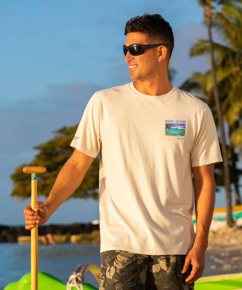 Man with a creamy white t-shirt with a small logo, standing by water  View 3