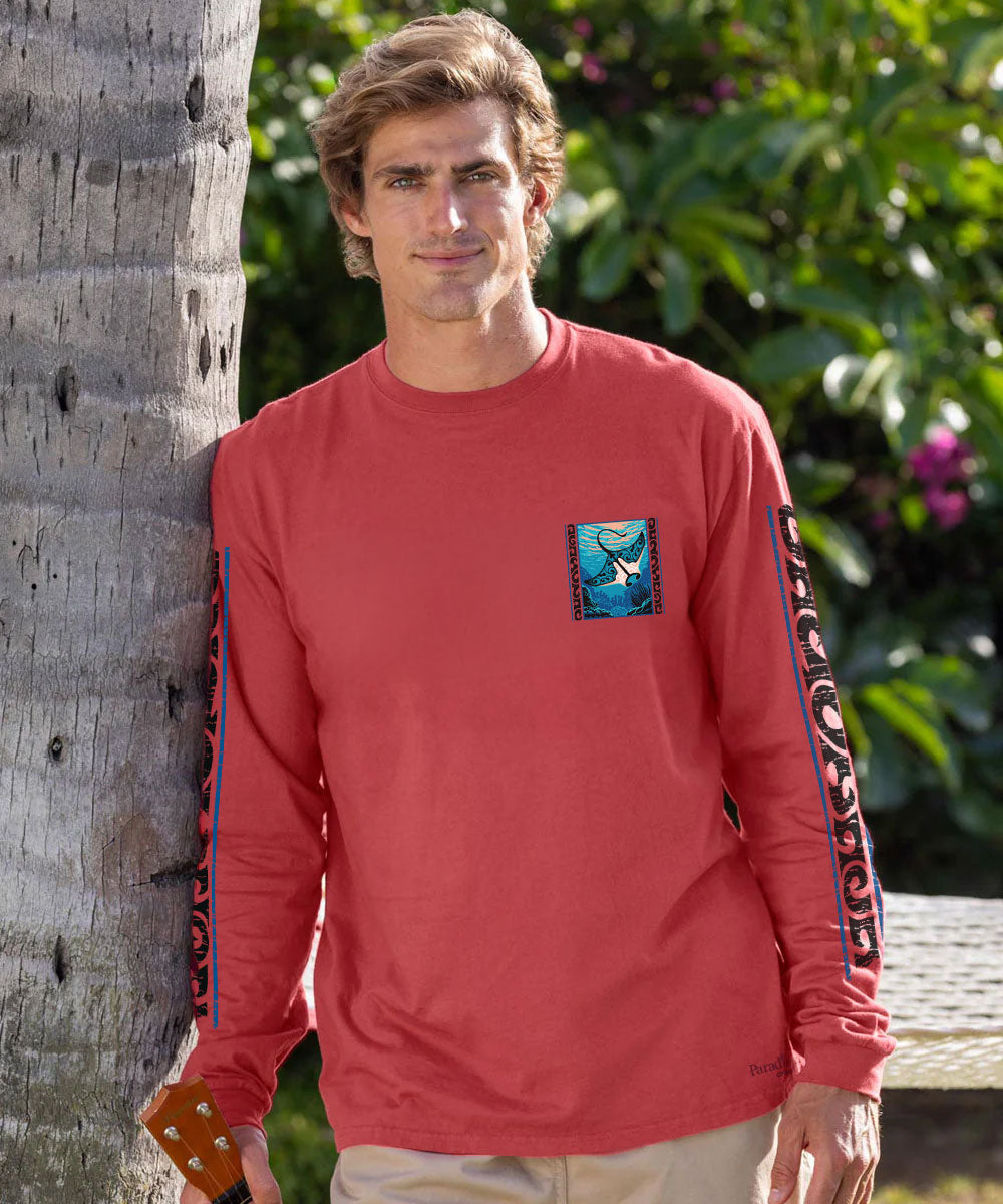 A man wearing a red long-sleeve crewneck sweatshirt with a blue and white graphic on the left chest and 'DUNGEON' printed vertically in black on the right sleeve, paired with dark jeans and sunglasses. View 3