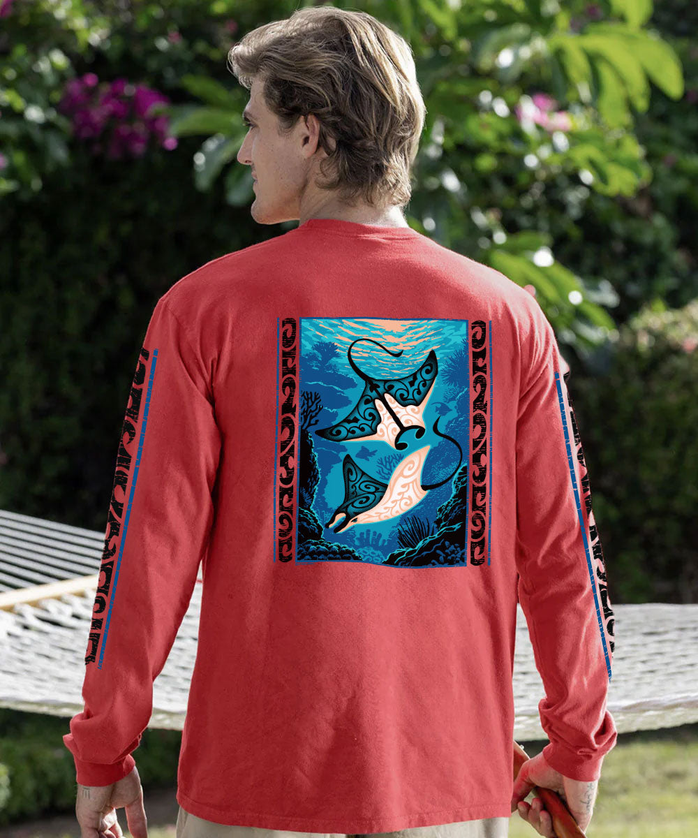 A man wearing a coral red crewneck sweatshirt, viewed from the back. The sweatshirt features a large graphic print of two manta rays swimming underwater in a blue ocean, framed by black tribal-style borders. View 2