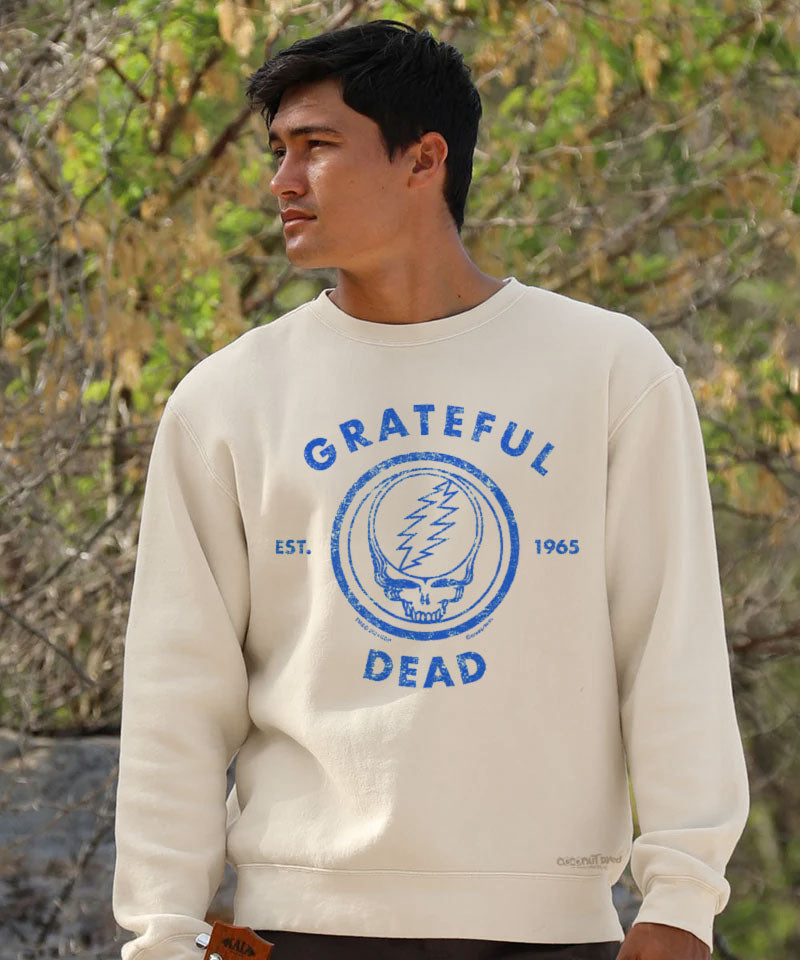 Person wearing a creamy white 'Grateful Dead' sweatshirt standing outdoors View 2