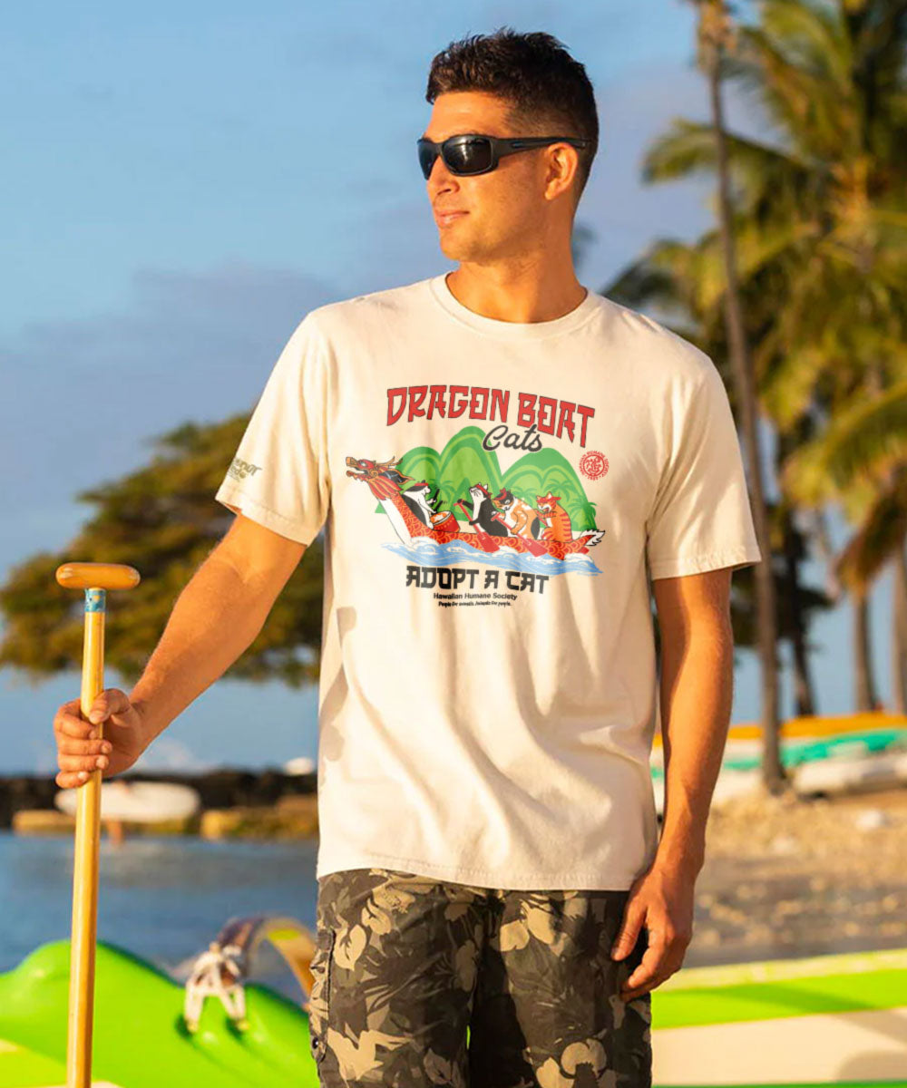 Man wearing a t-shirt with a dragon boat design and text outdoors. View 2