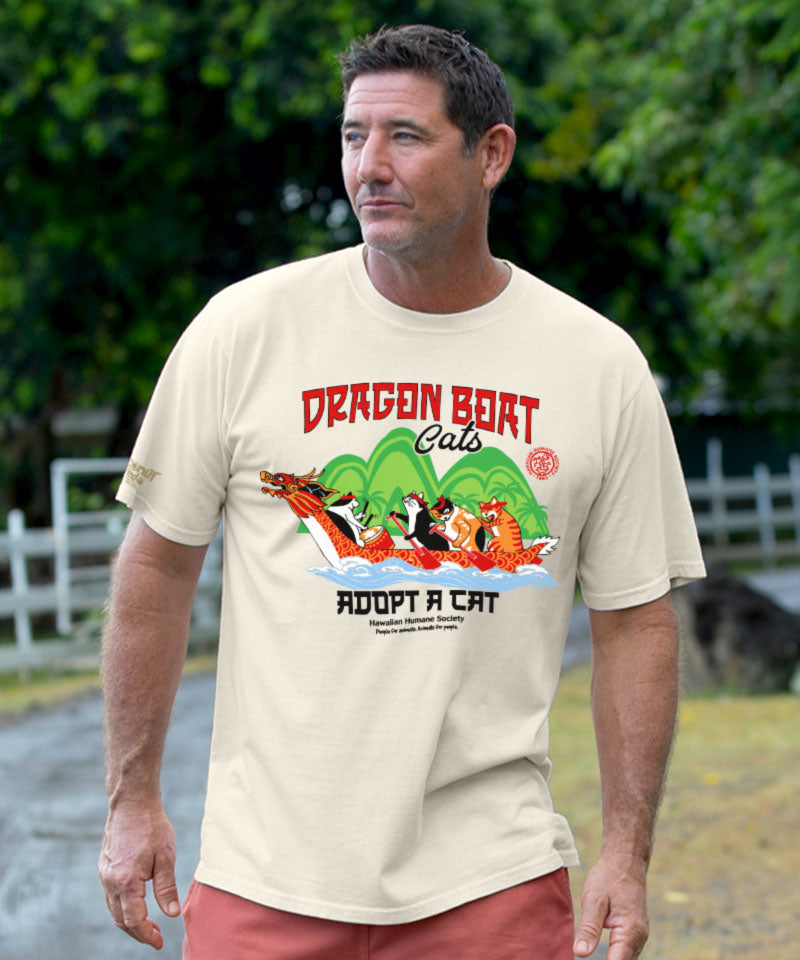 Man wearing a t-shirt with a dragon boat design and text outdoors.