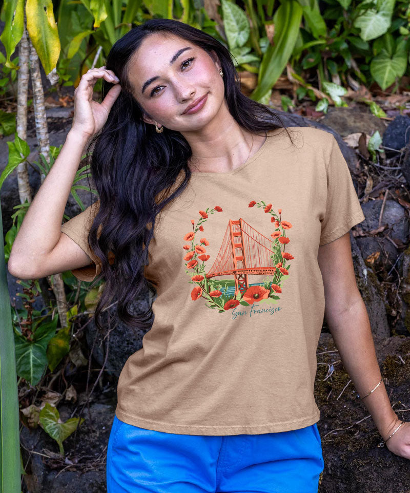Woman wearing a t-shirt with a Golden Gate Bridge graphic in a natural setting View 2