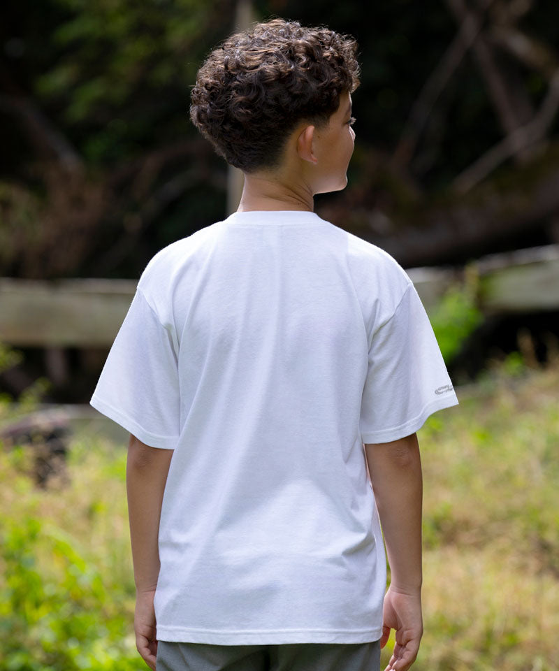 Person wearing a white t-shirt standing outdoors with greenery in the background View 3