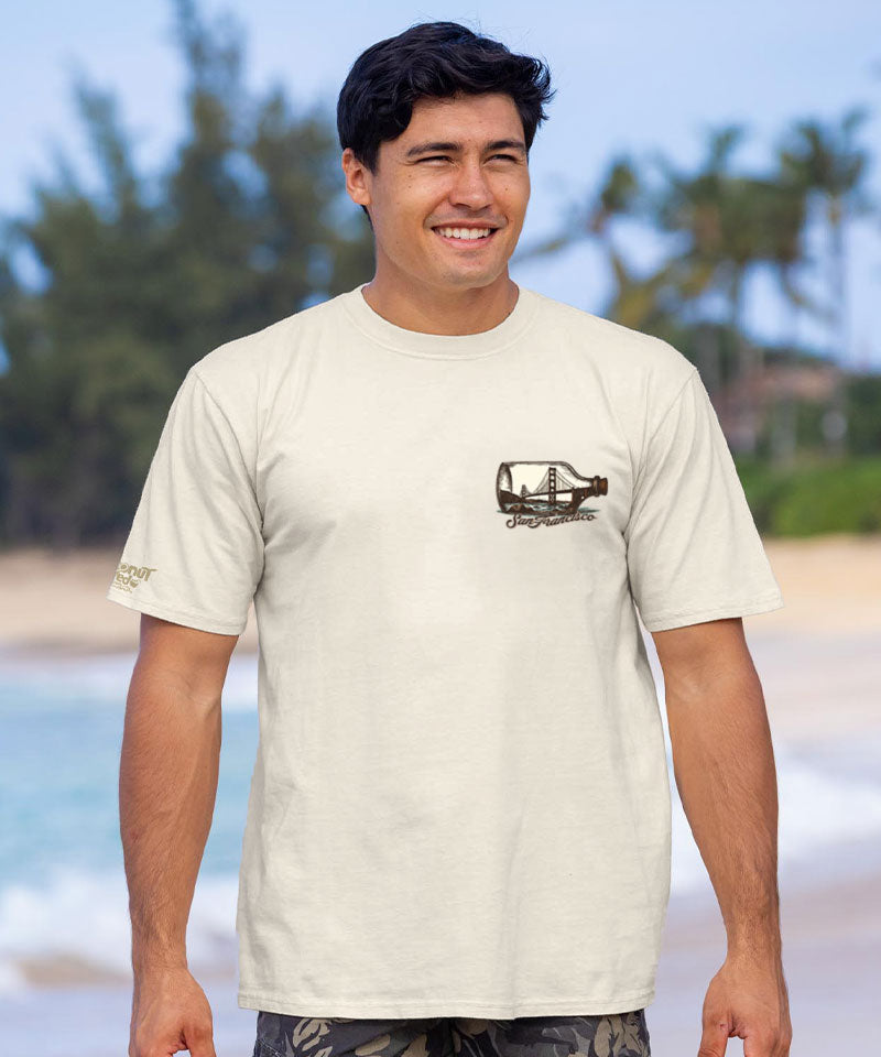 Man wearing a white t-shirt with a graphic design on a beach View 3