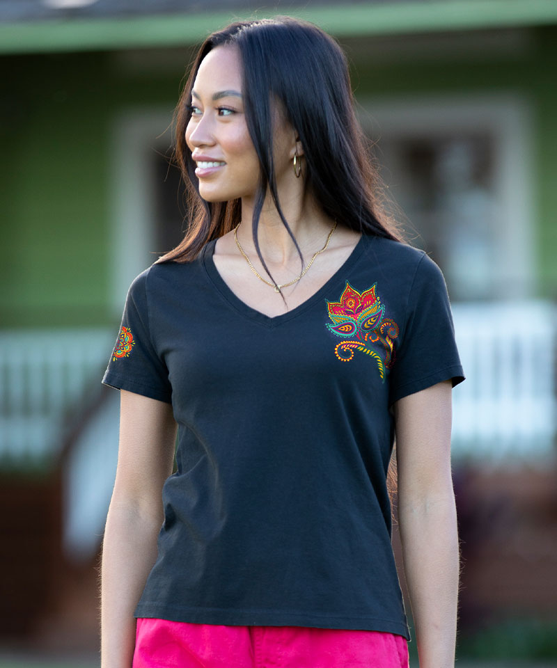 Woman wearing a black t-shirt with colorful designs outdoors View 2