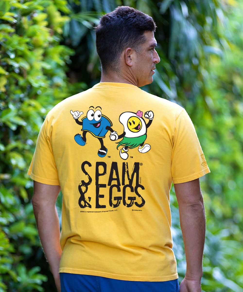Person wearing a yellow t-shirt with cartoon characters and 'SPAM & EGGS' text, standing outdoors. View 2