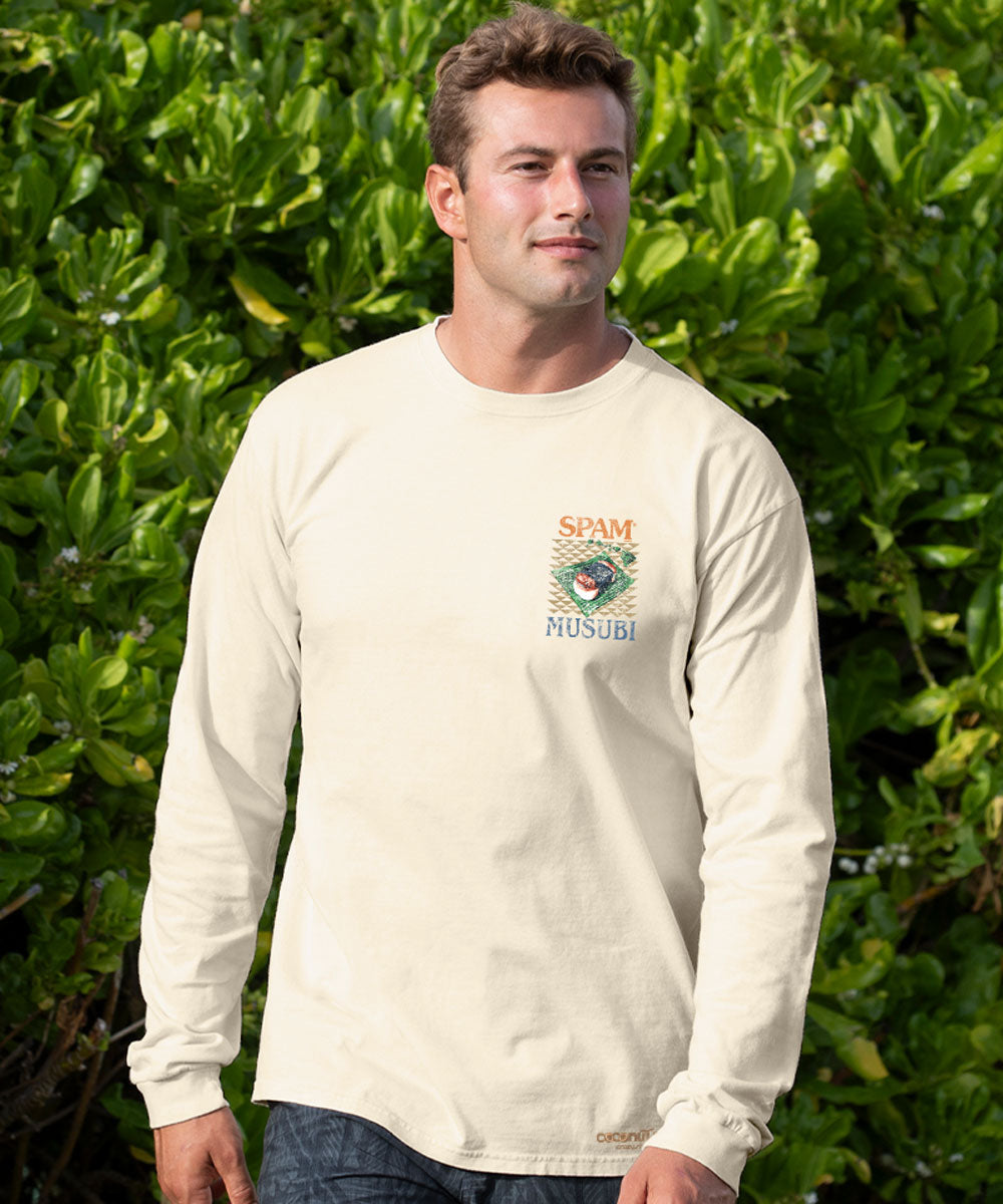 Man wearing a white long-sleeve shirt with a logo in front of green foliage View 3