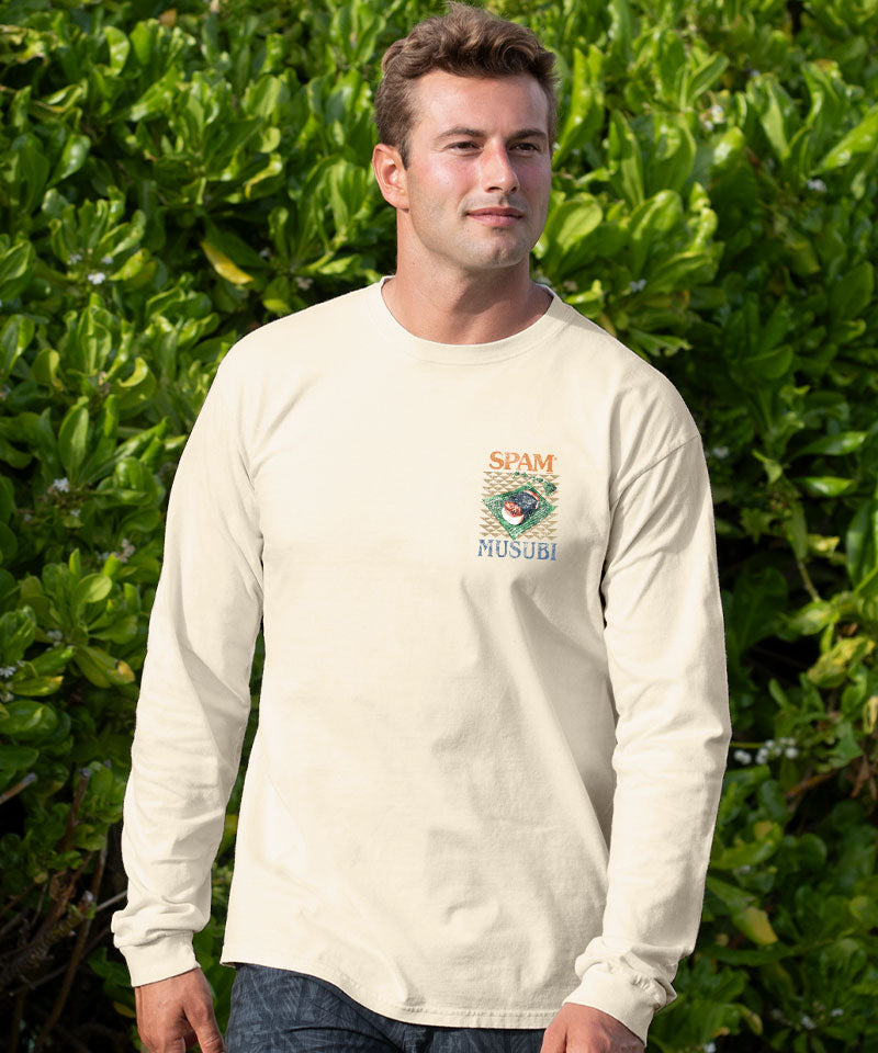 Man wearing a white long-sleeve shirt with a logo in front of green foliage View 3
