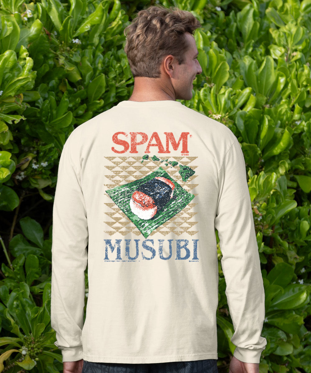 A man viewed from behind wearing a cream-colored long-sleeve t-shirt with a humorous 'SPAM MUSubi' graphic on the back, set against a background of lush green foliage. View 2