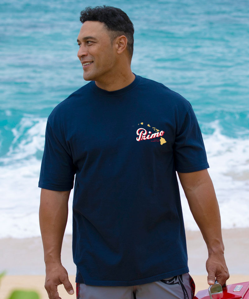 Man wearing a navy blue t-shirt with a logo on a beach View 3