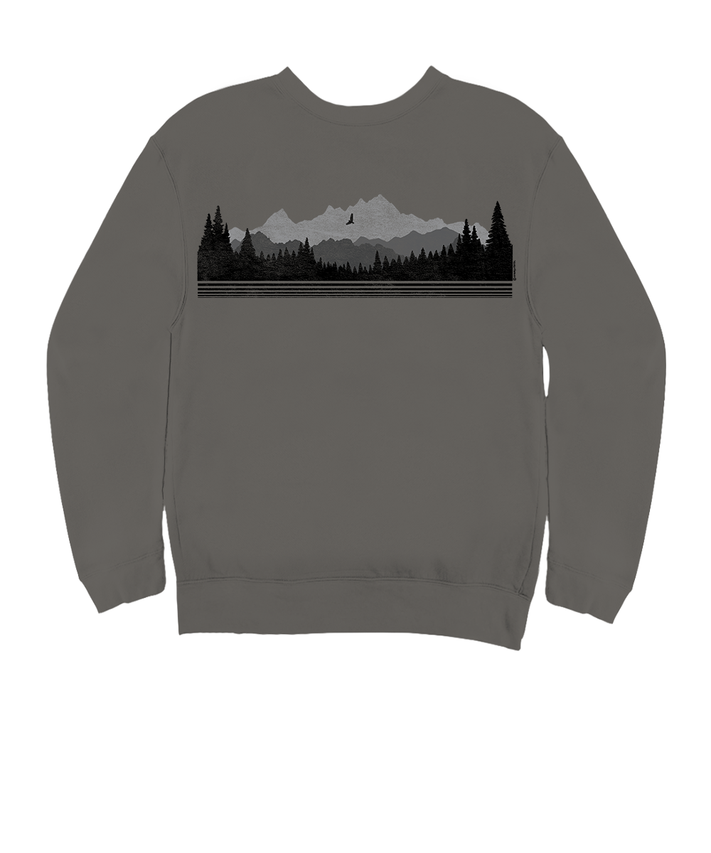 A dark gray crewneck sweatshirt featuring a horizontal graphic print of a mountain and forest landscape in black and gray tones across the chest. View 4
