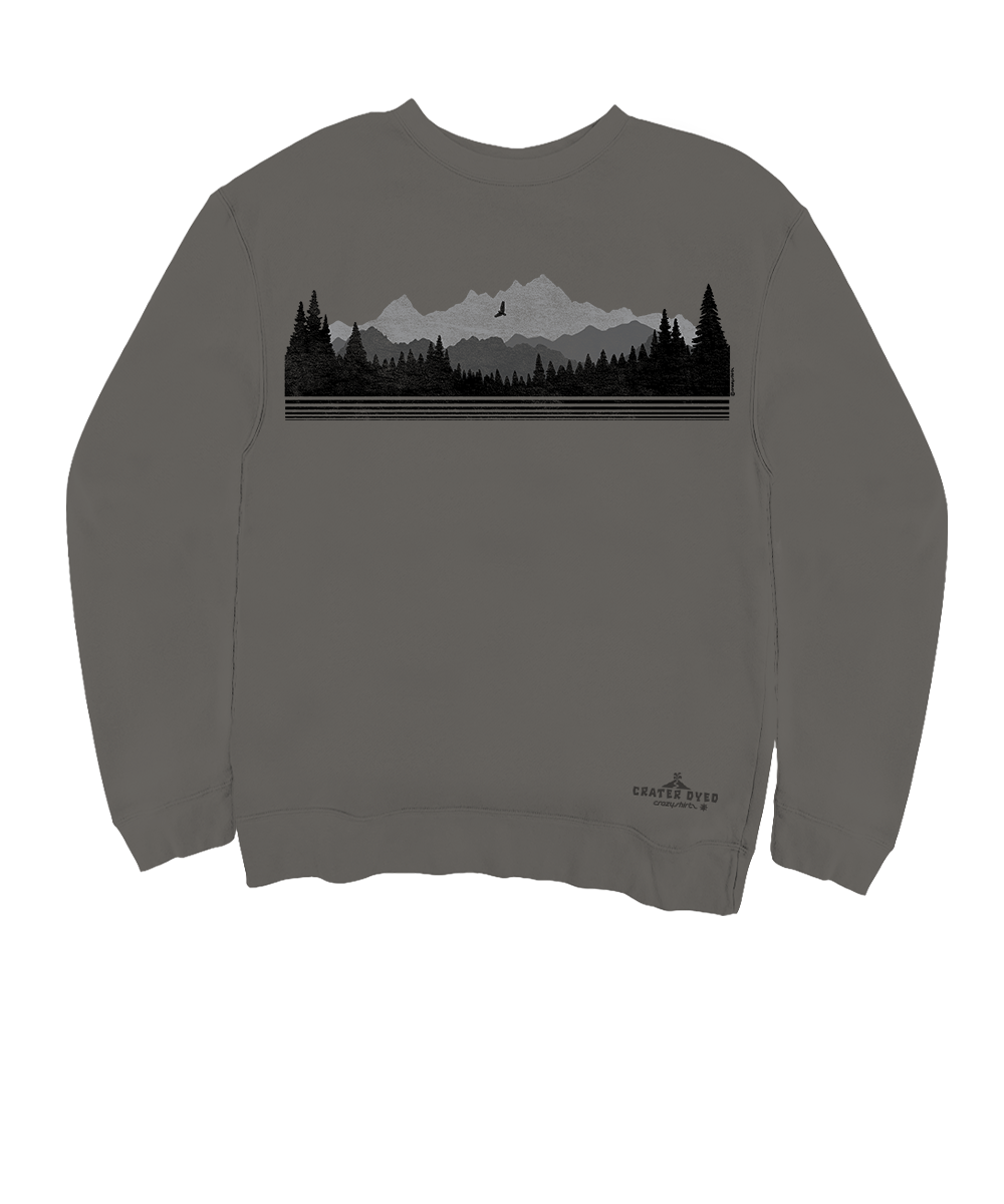 A dark gray crewneck sweatshirt featuring a black and gray graphic of a mountain range, pine trees, and a moon on the chest, with a small 'Crafty Tree Co.' logo near the bottom right hem. View 1