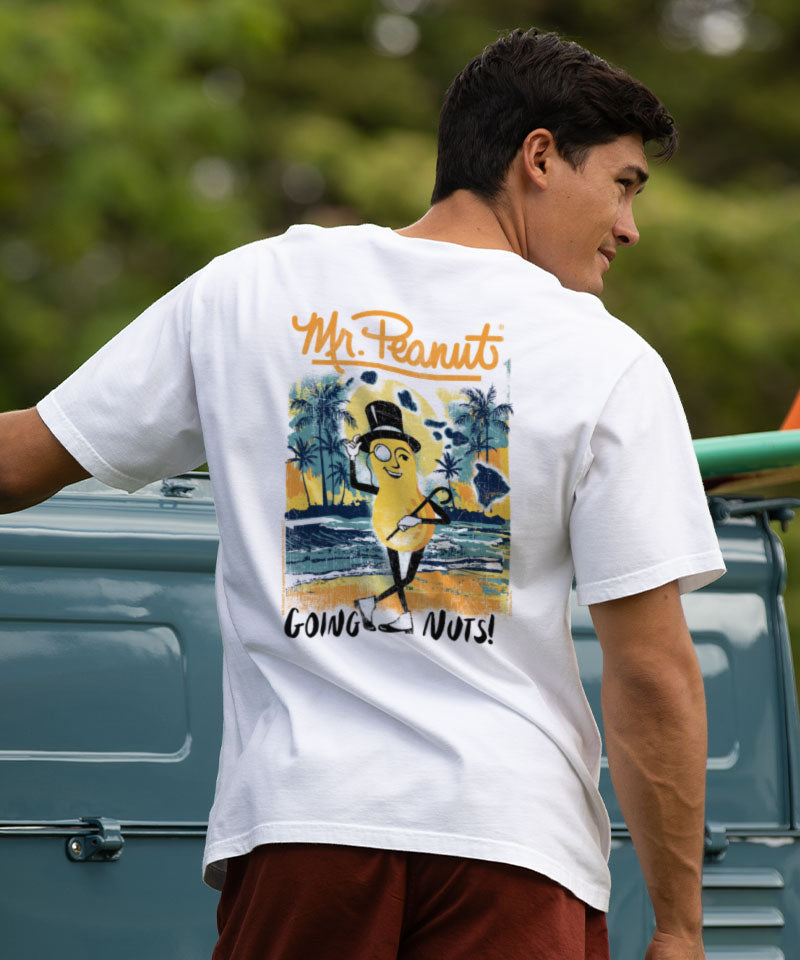 Person wearing a white t-shirt with a colorful graphic on the back, standing outdoors. View 2