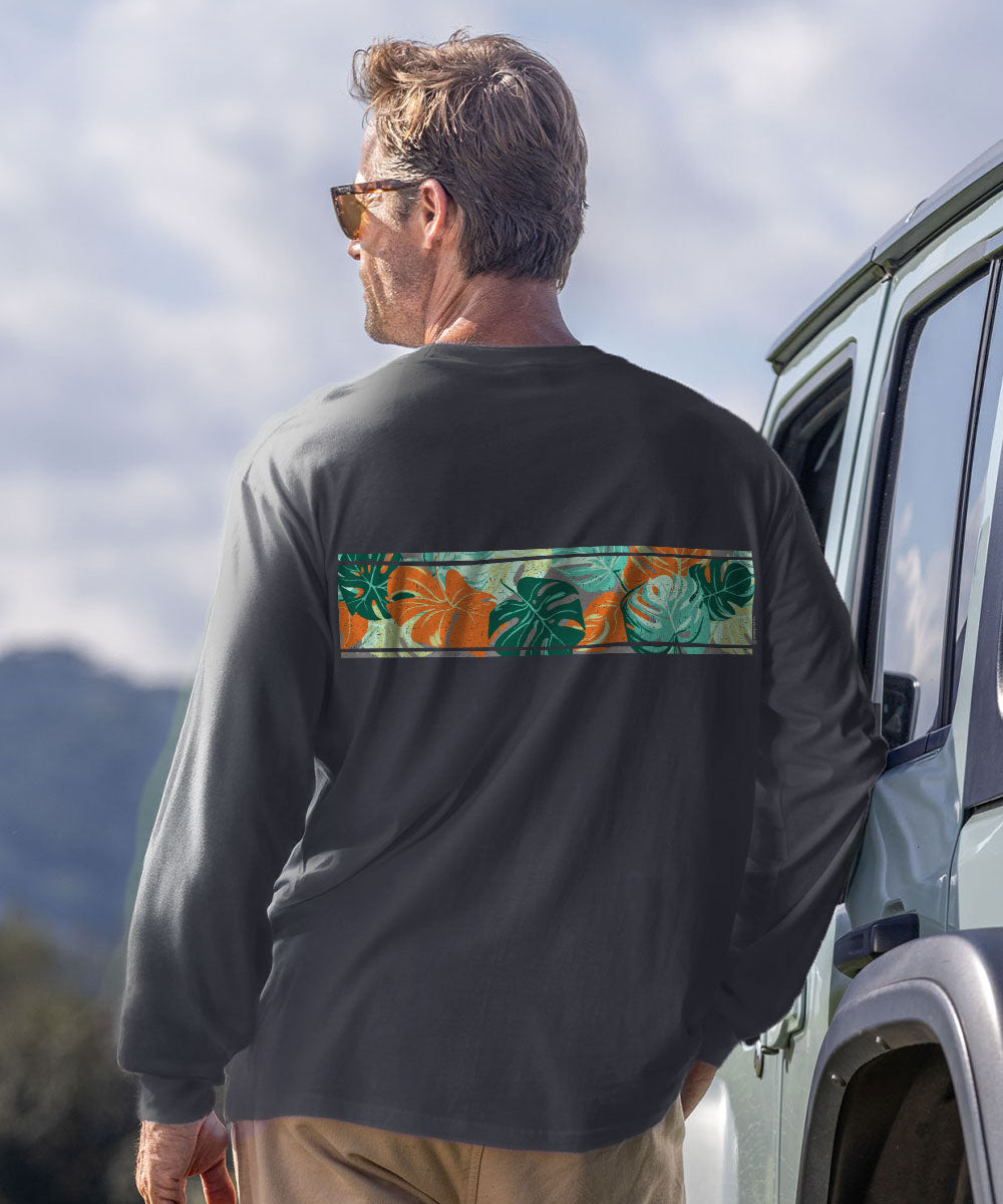 A man wearing a dark charcoal long-sleeve shirt with a horizontal tropical floral print band across the back, standing next to a vehicle outdoors. View 3