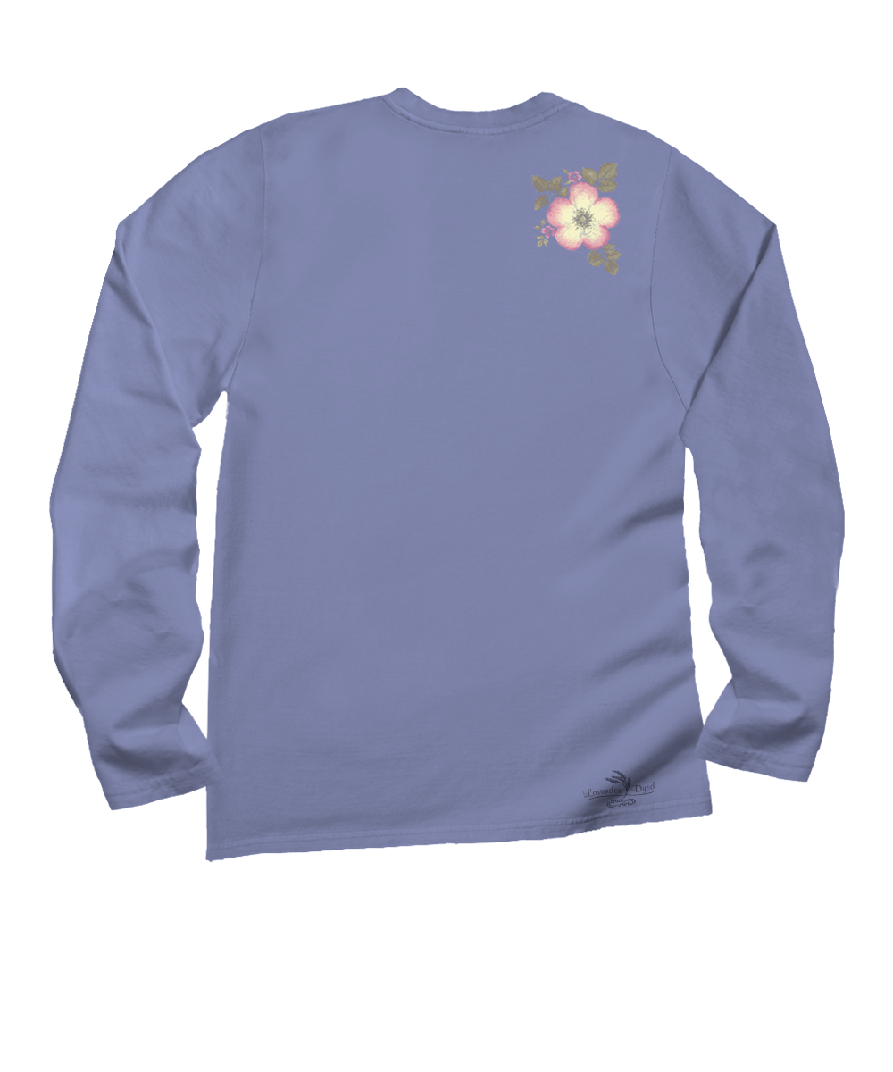 A light periwinkle blue long-sleeve t-shirt shown from the back, featuring a small pink and white flower graphic with green leaves on the upper right shoulder and a small black logo near the lower left hem. View 4