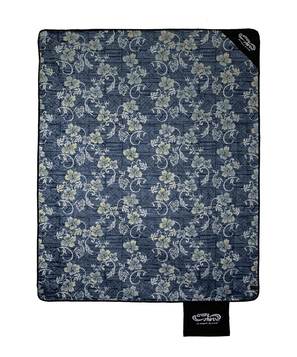 A rectangular quilted blanket by Comfort Colors featuring a navy blue background with a light beige and white floral vine pattern, shown flat against a white background. View 1