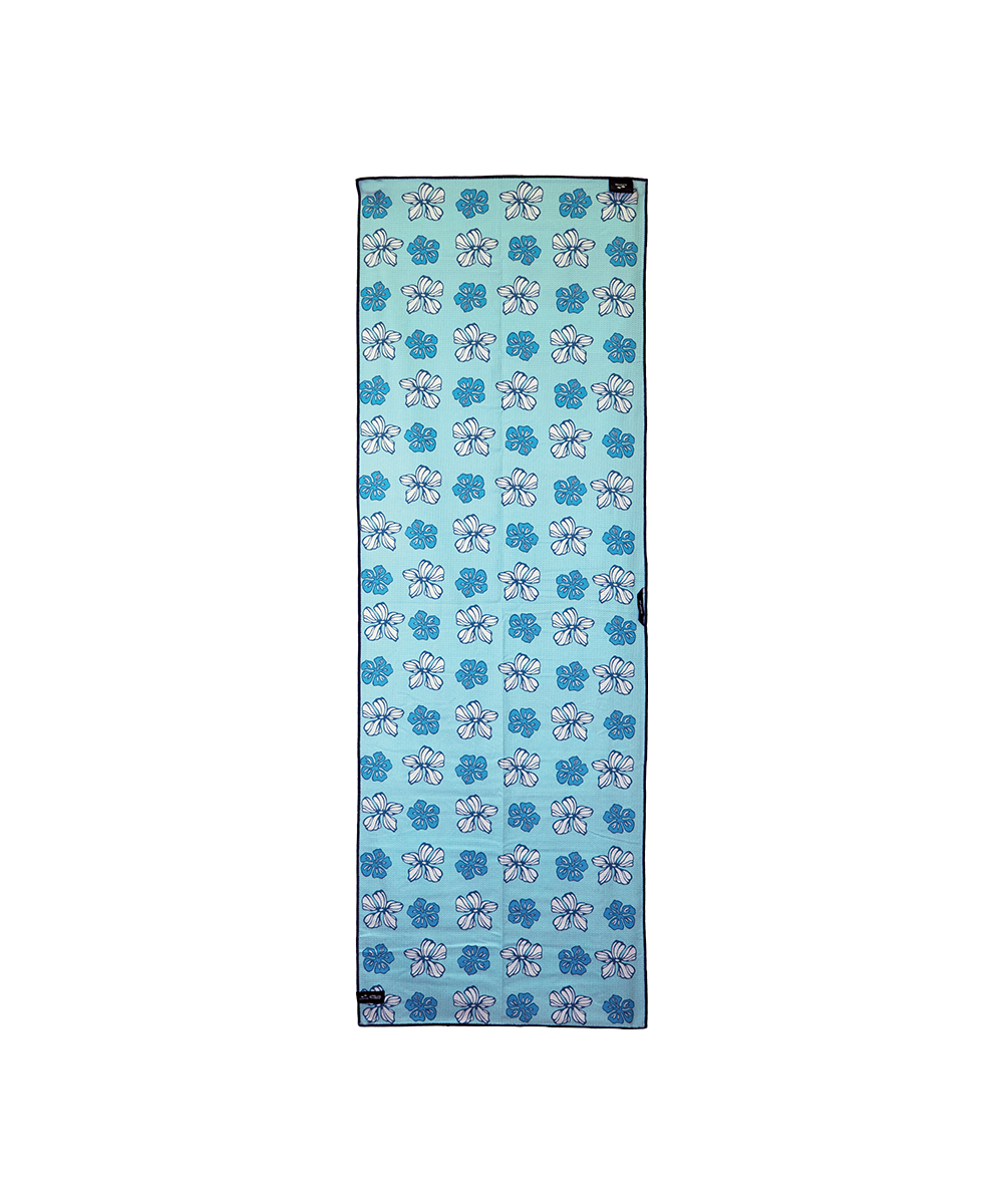 A rectangular yoga mat with a repeating pattern of blue and white lotus flowers on a light blue background, shown flat against a white background. View 2