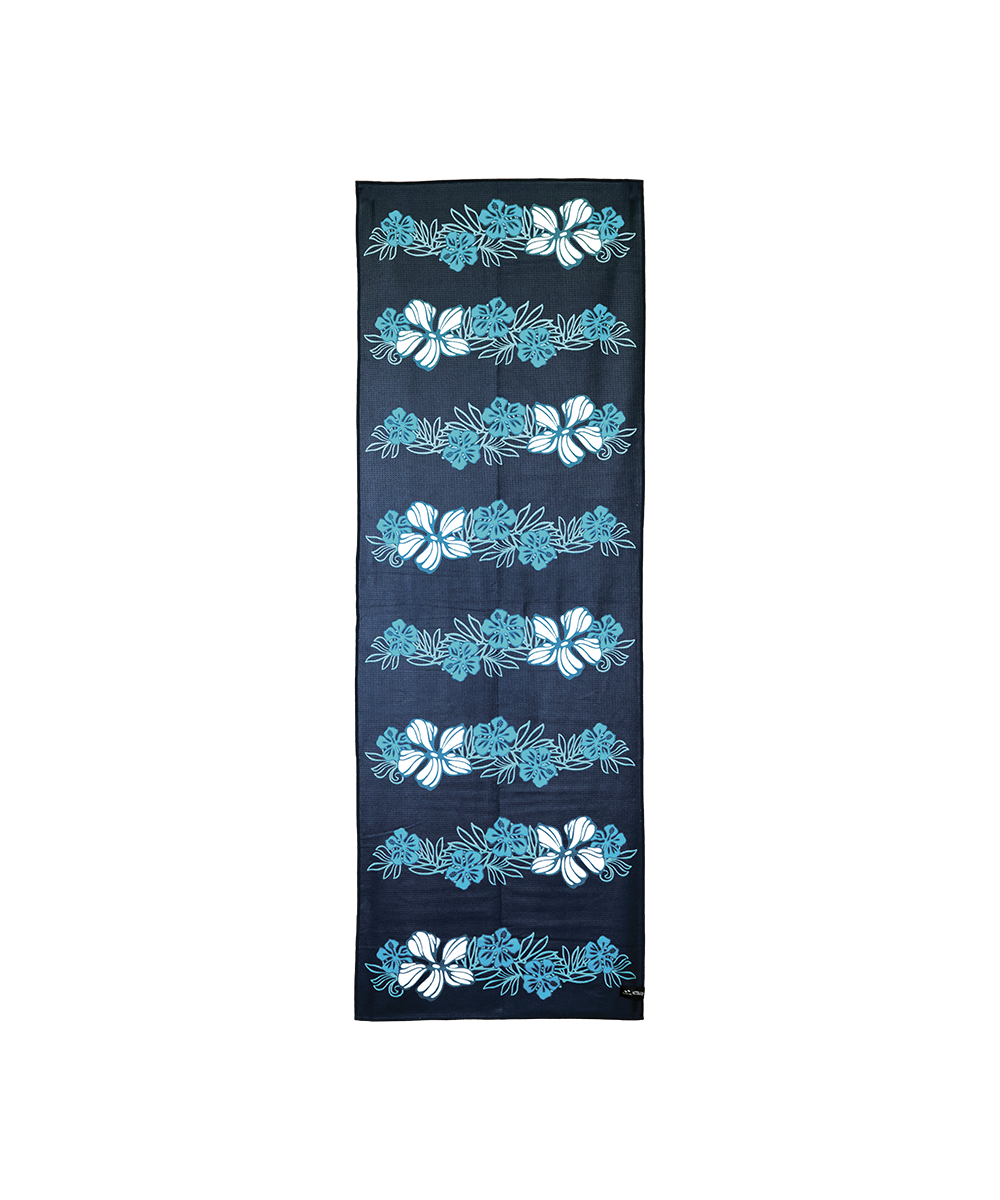 A long rectangular navy blue scarf or towel featuring a vertical pattern of light blue and white hibiscus flowers and tropical leaves, shown flat against a white background. View 1
