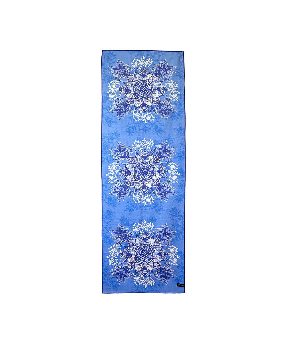 A long rectangular scarf in medium blue with three vertical rows of white and light blue floral mandala patterns, shown flat against a white background. View 1