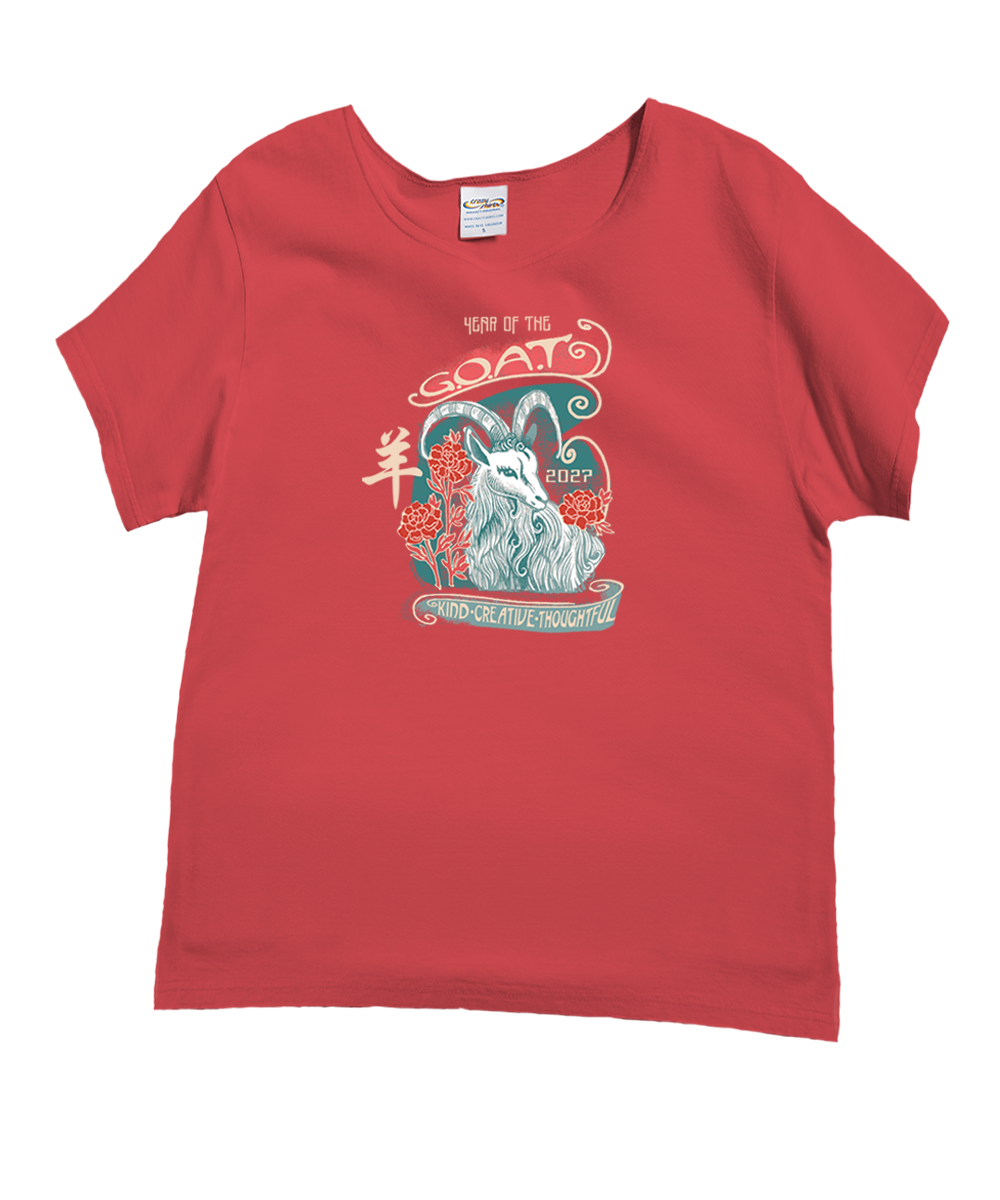 A red short-sleeve crewneck t-shirt featuring a graphic print of a goat with the text 'YEAR OF THE GOAT 2027' and 'KIND-CREATIVE-THOUGHTFUL'. View 1