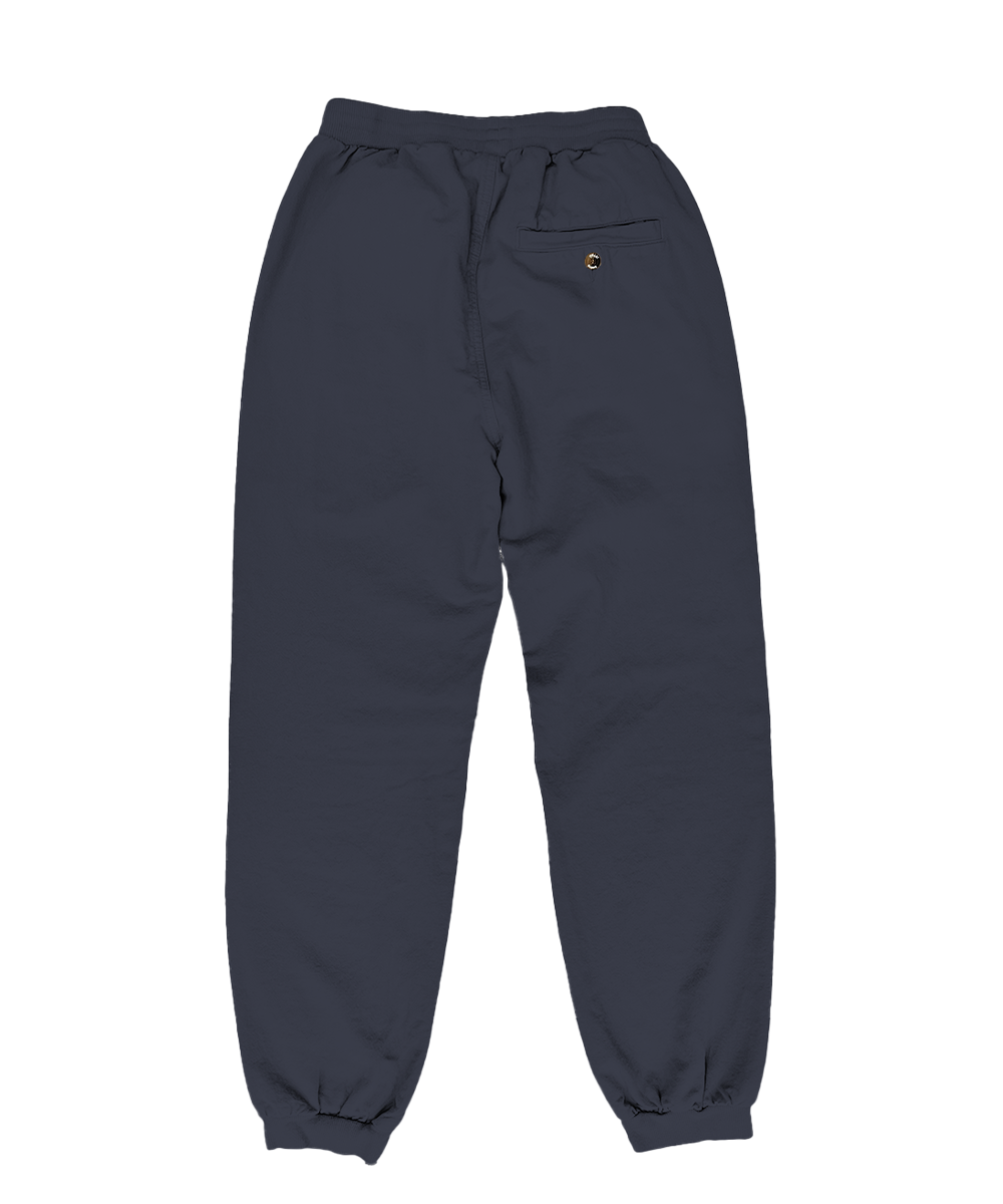 A pair of dark navy blue sweatpants with an elastic waistband, drawstring, and elastic cuffs, featuring a small yellow embroidered logo on the left hip. View 4