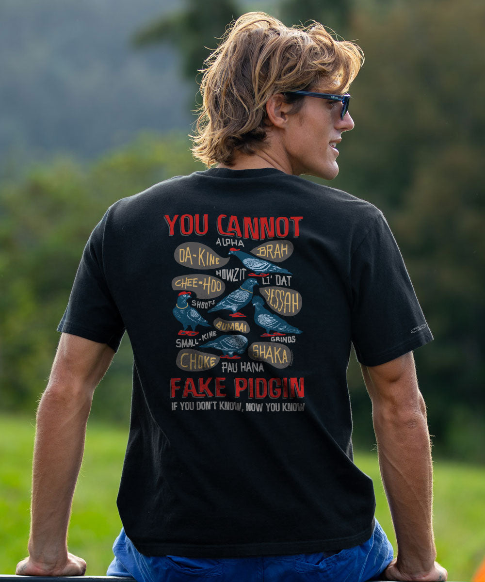 A man wearing a black graphic t-shirt, viewed from behind, standing outdoors in a grassy field. The shirt features a detailed back graphic with the words 'YOU CANNOT' and 'FAKE PIGGIN' in red. View 2