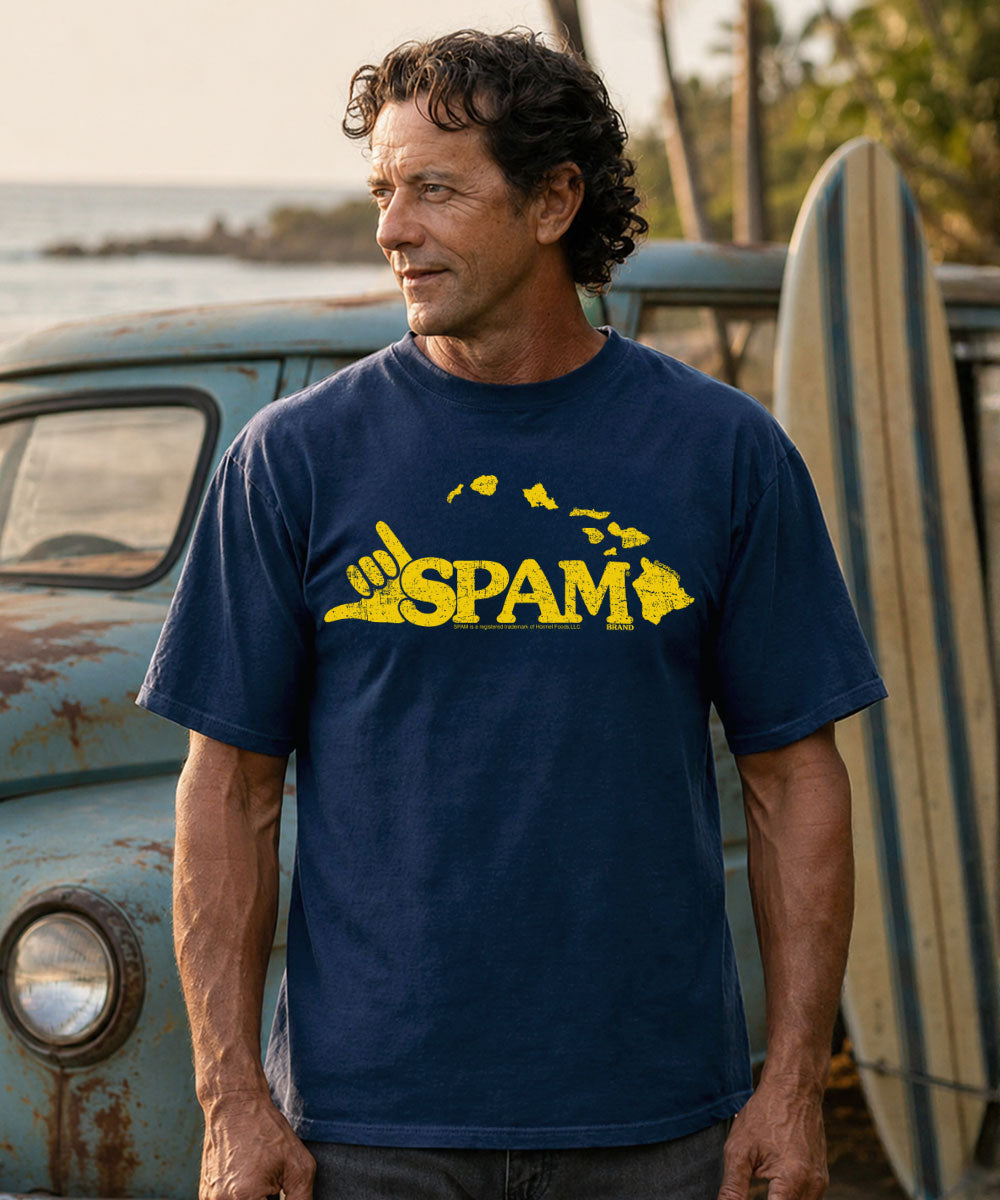 Man wearing a blue t-shirt with a yellow 'SPAM' logo outdoors. View 2