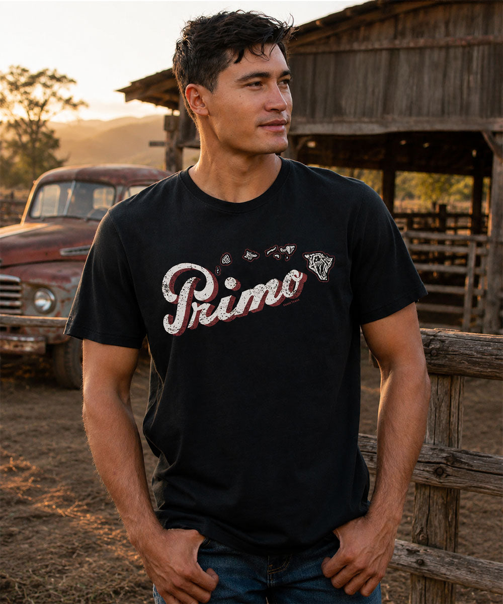 Man wearing a black t-shirt with 'Primo' logo outdoors View 2