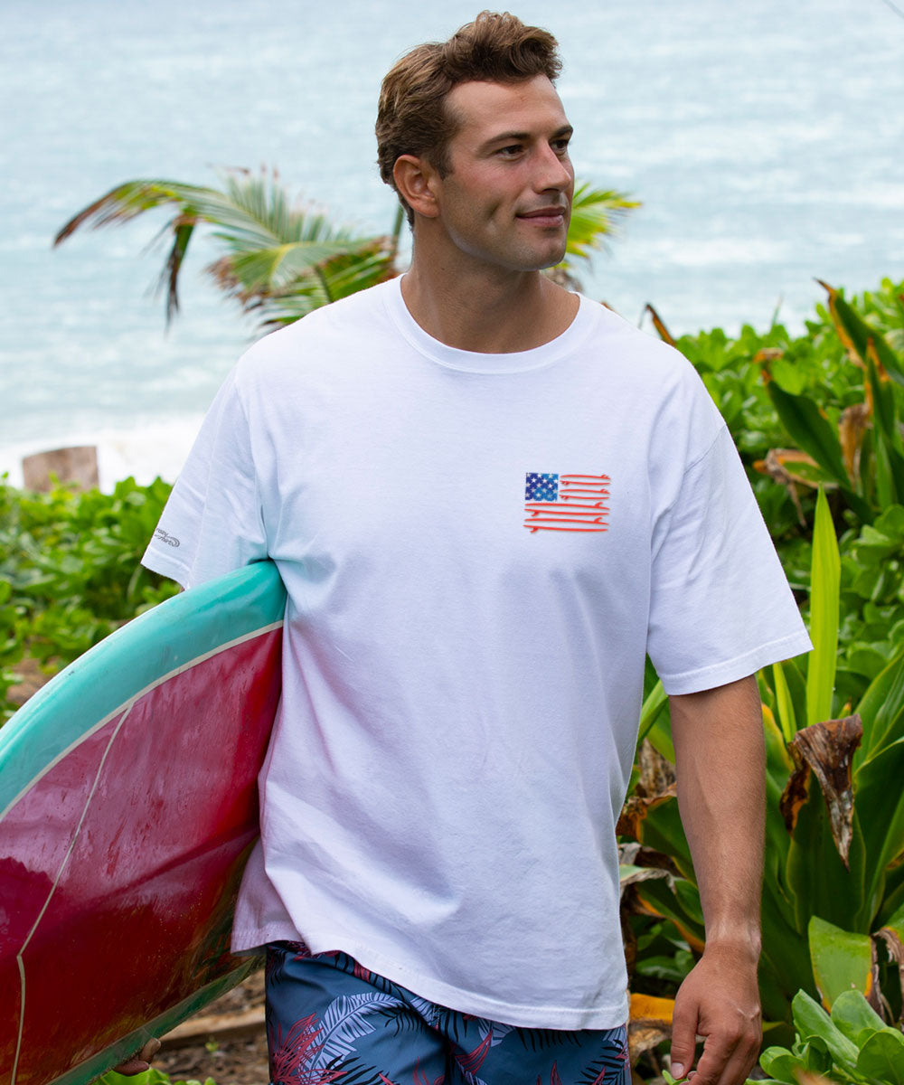 Man holding a surfboard with a scenic background View 3