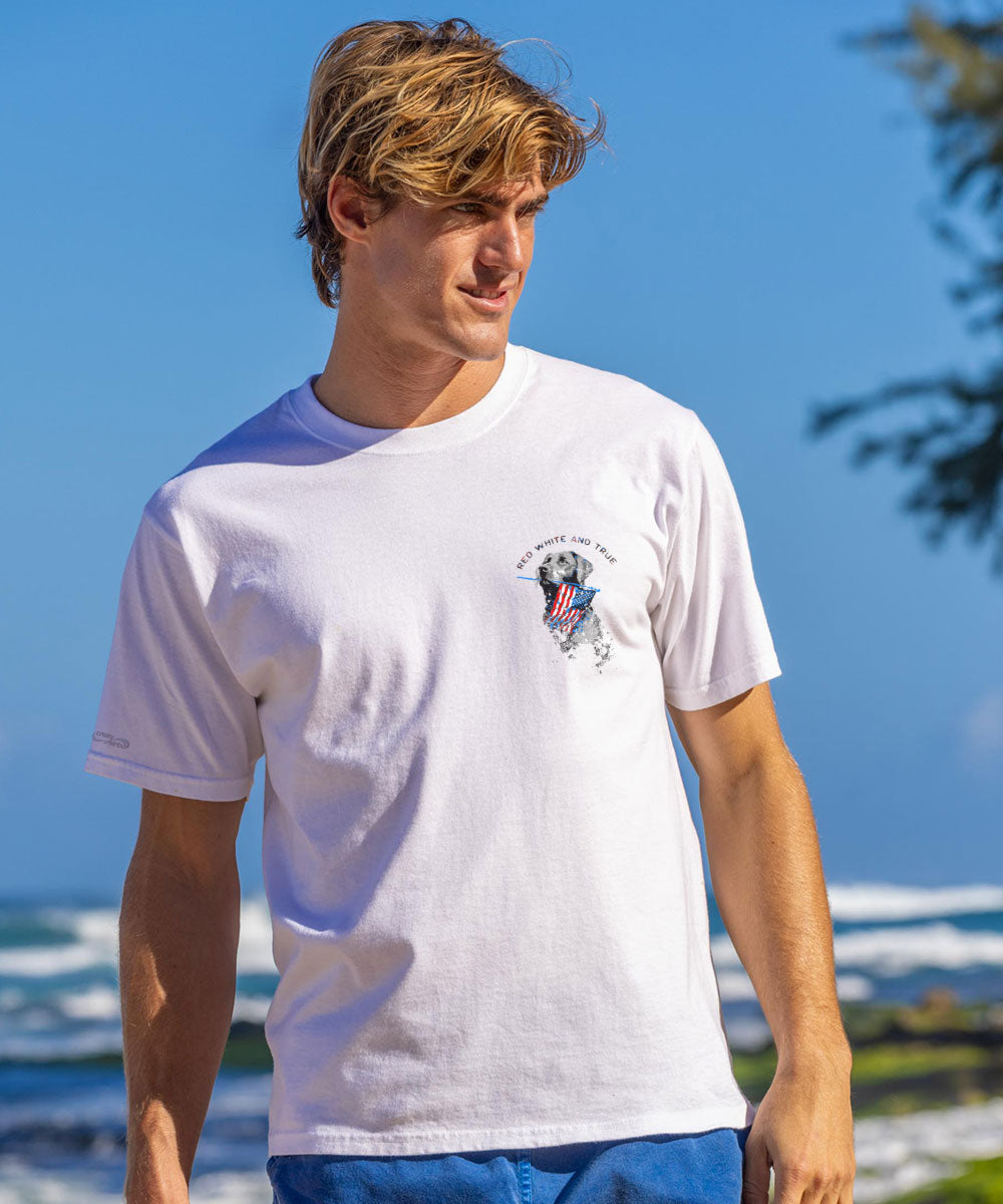 Man wearing a white t-shirt with a logo on a beach View 3