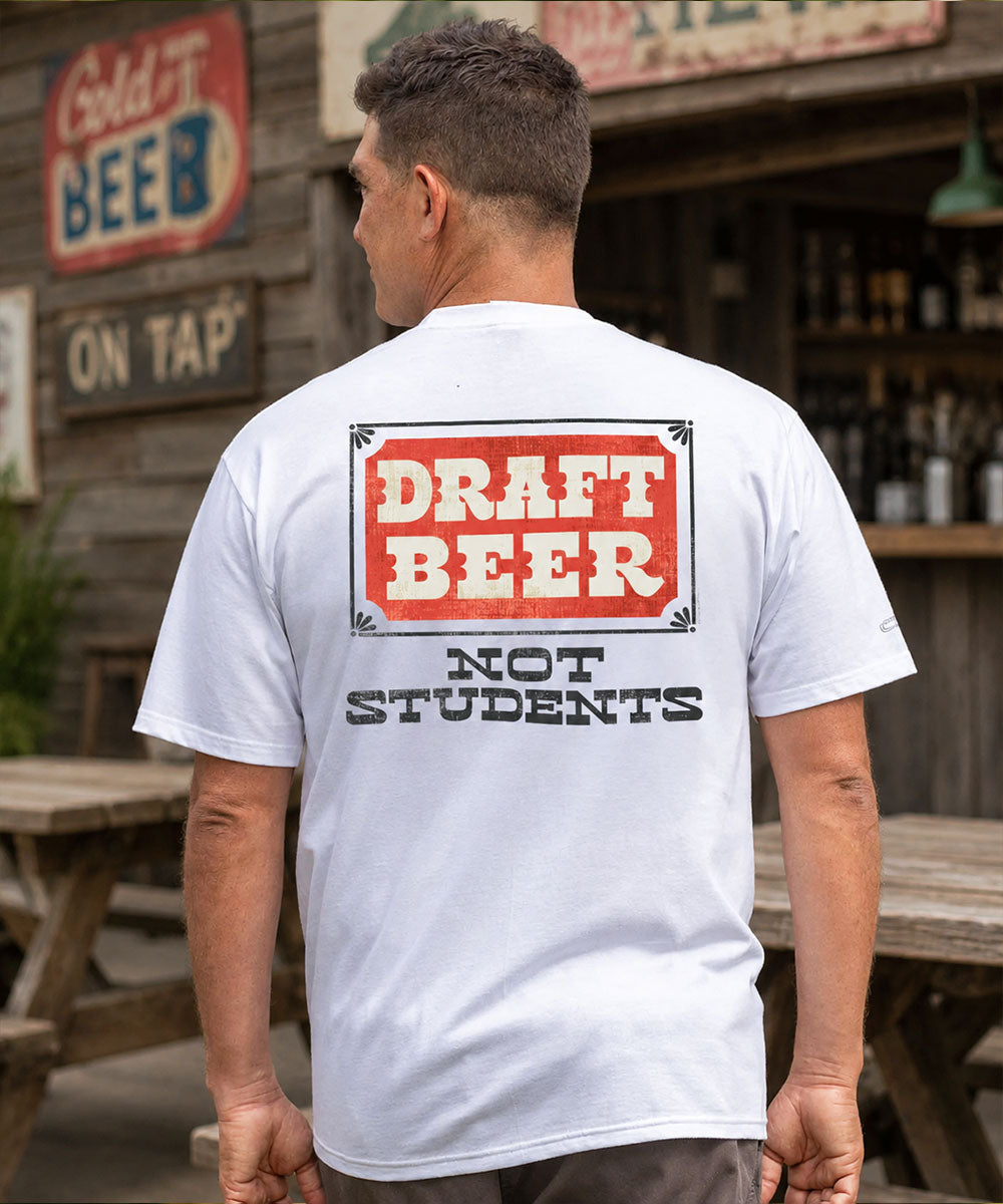 Man wearing a white t-shirt with 'Draft Beer Not Students' text on the back, standing outdoors. View 2