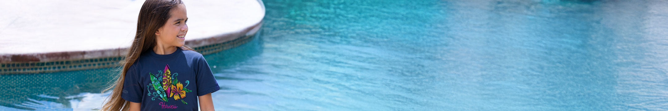 child next to a pool wearing a navy shirt
