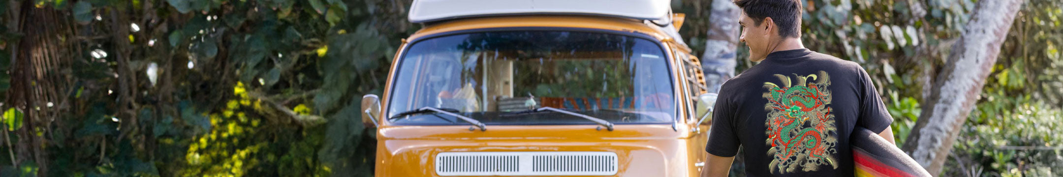 Person with a surfboard standing next to a vintage van in a natural setting