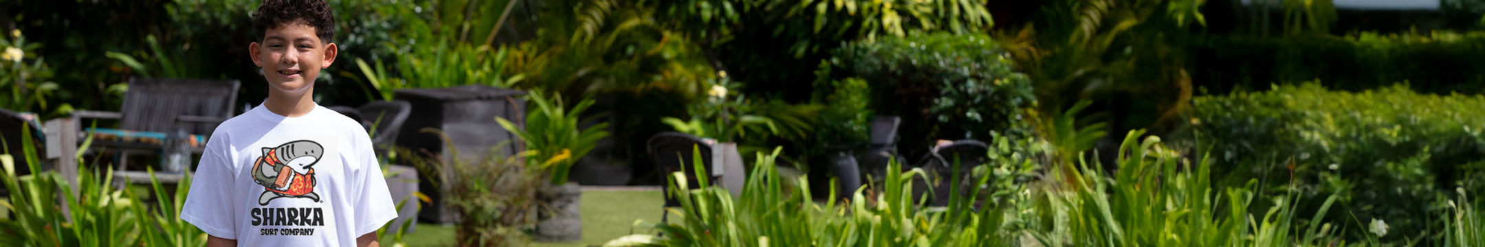 Person wearing a white t-shirt with a graphic design in an outdoor setting