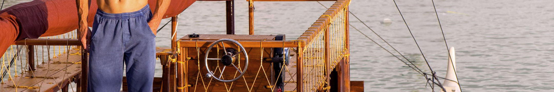 Man wearing Blueberry Dyed Twill Pants standing on a boat