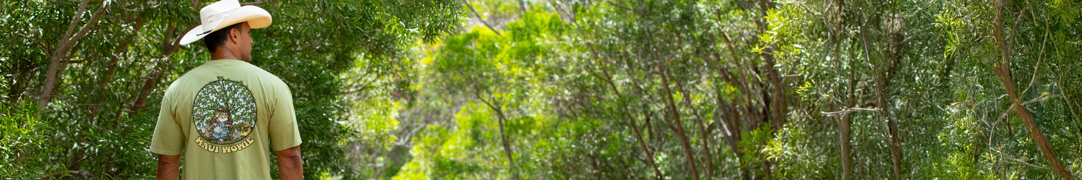 Person wearing a Hemp Dyed t-shirt with a tree design, standing in a forest.