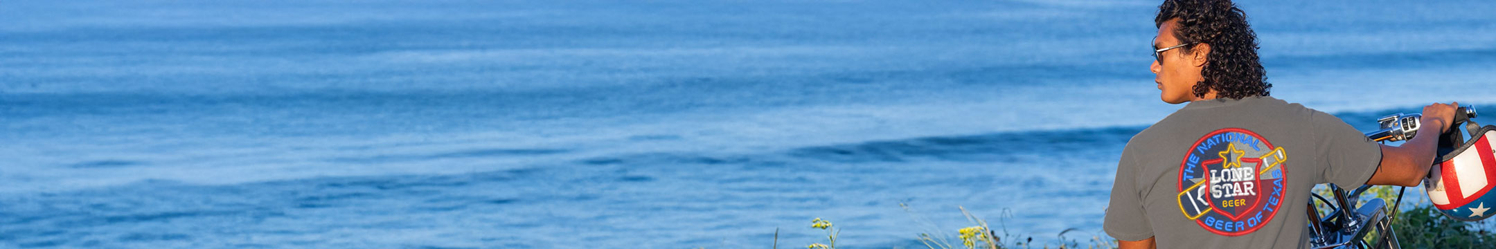Person with a backpack looking out at the ocean