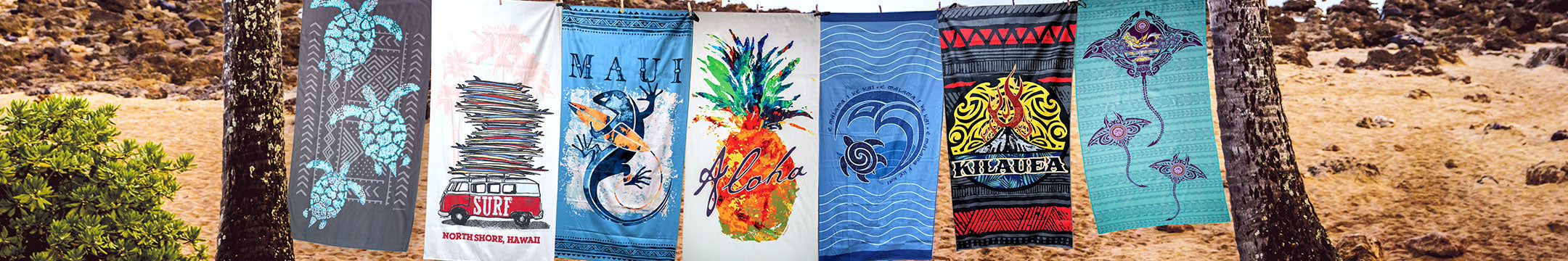 Collection of colorful beach towels hanging on a line outdoors.