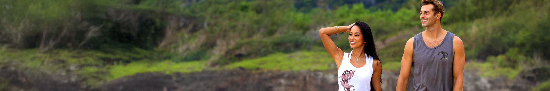 Two people walking together in a natural setting with greenery.