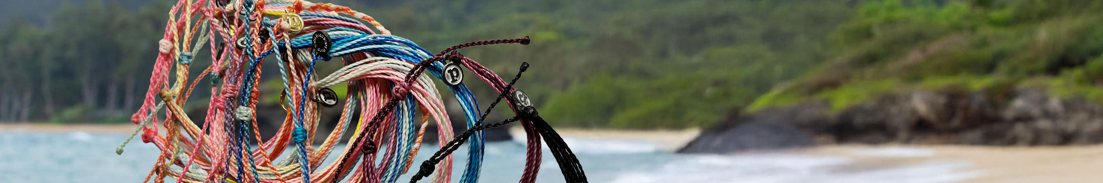 Puravida bracelets featured with a beach scene in the background