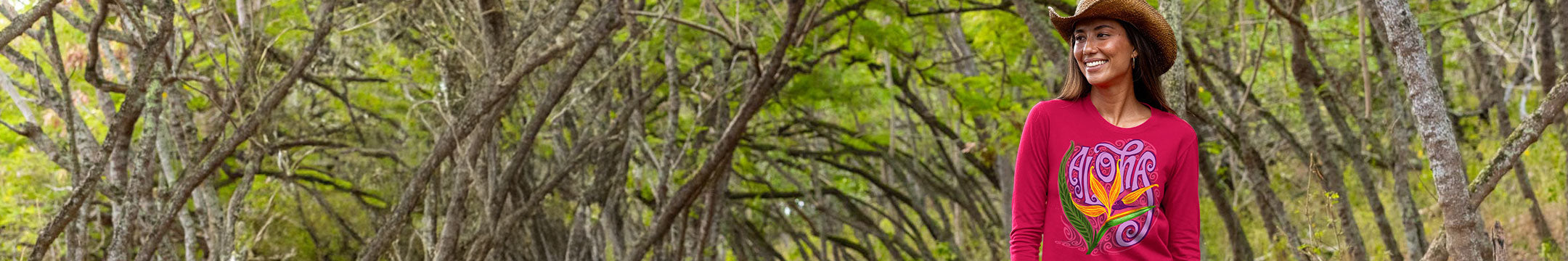 Woman wearing a floral crazy shirt with a colorful design, standing in a forest.