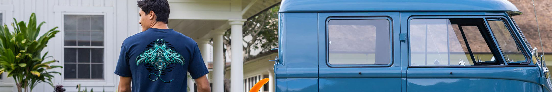 Man wearing a blue t-shirt with a Manta graphic design, standing next to a blue van.