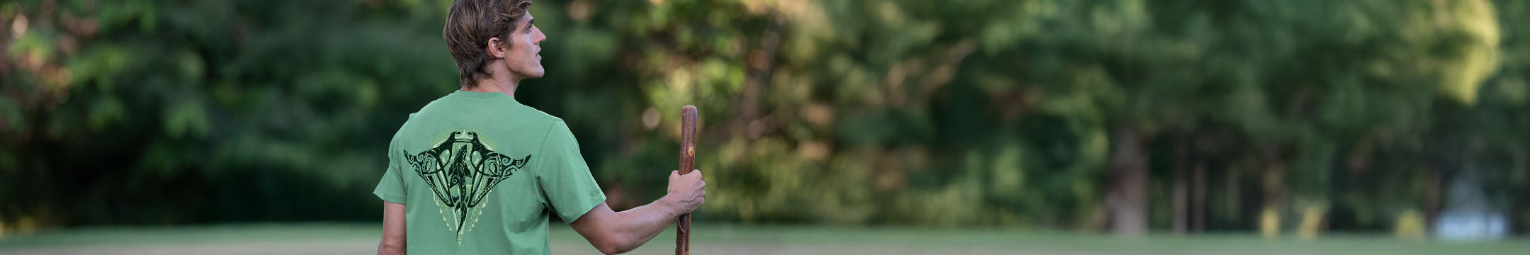 Person wearing a green t-shirt with a shark design outdoors