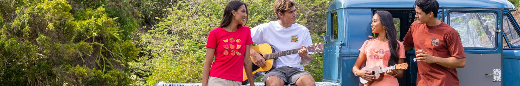 Two people playing guitar and ukulele in a scenic outdoor setting with a van in the background.