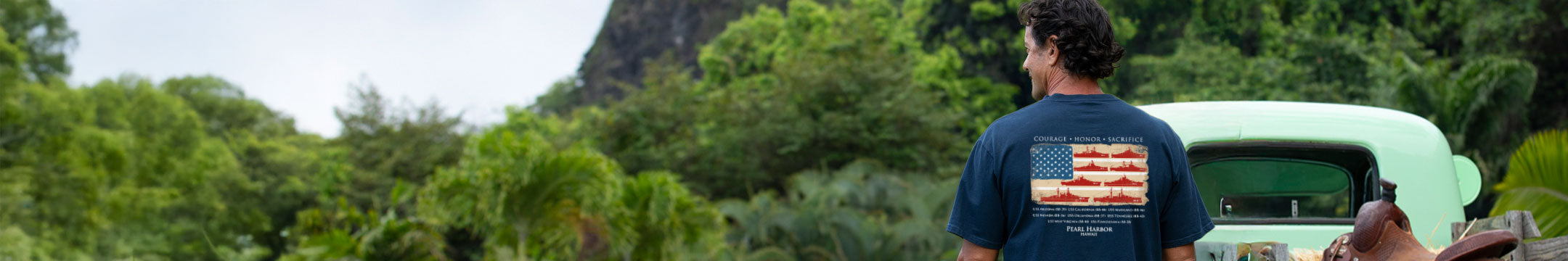 Person standing in a forest with a vehicle in the background