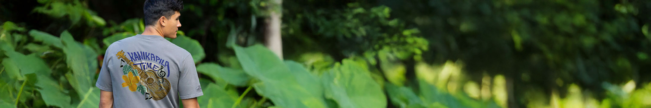 Person wearing a crater dyed t-shirt with a logo in a forest setting