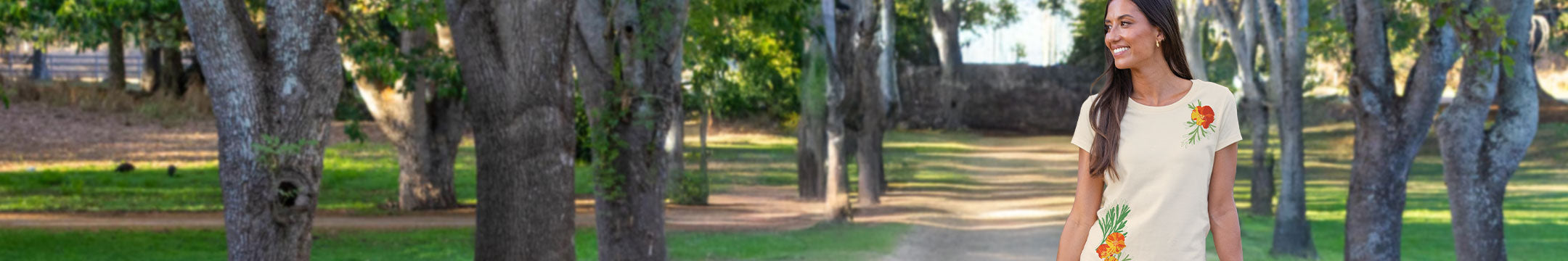 Woman walking in a park with trees and grass in the background
