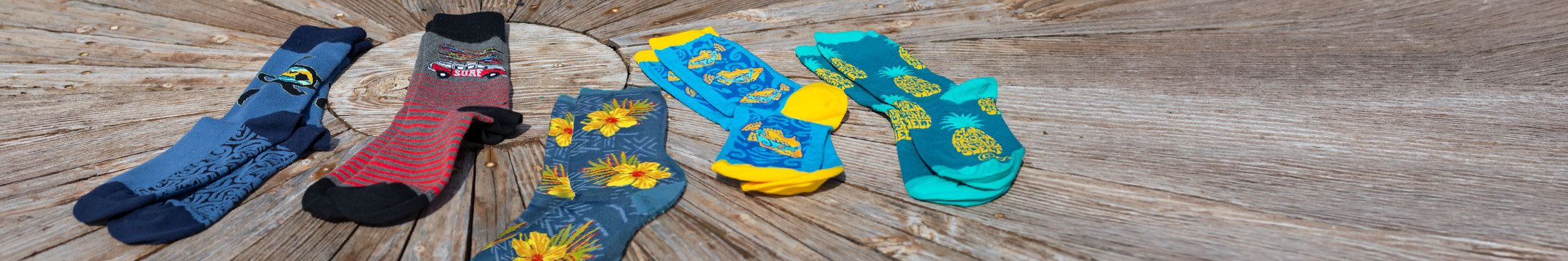 Colorful socks with cartoon designs on a textured surface