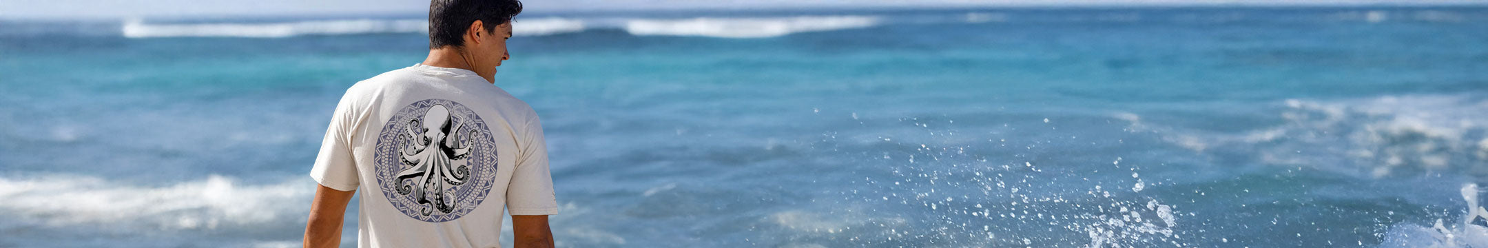 Person standing on a beach looking at the ocean